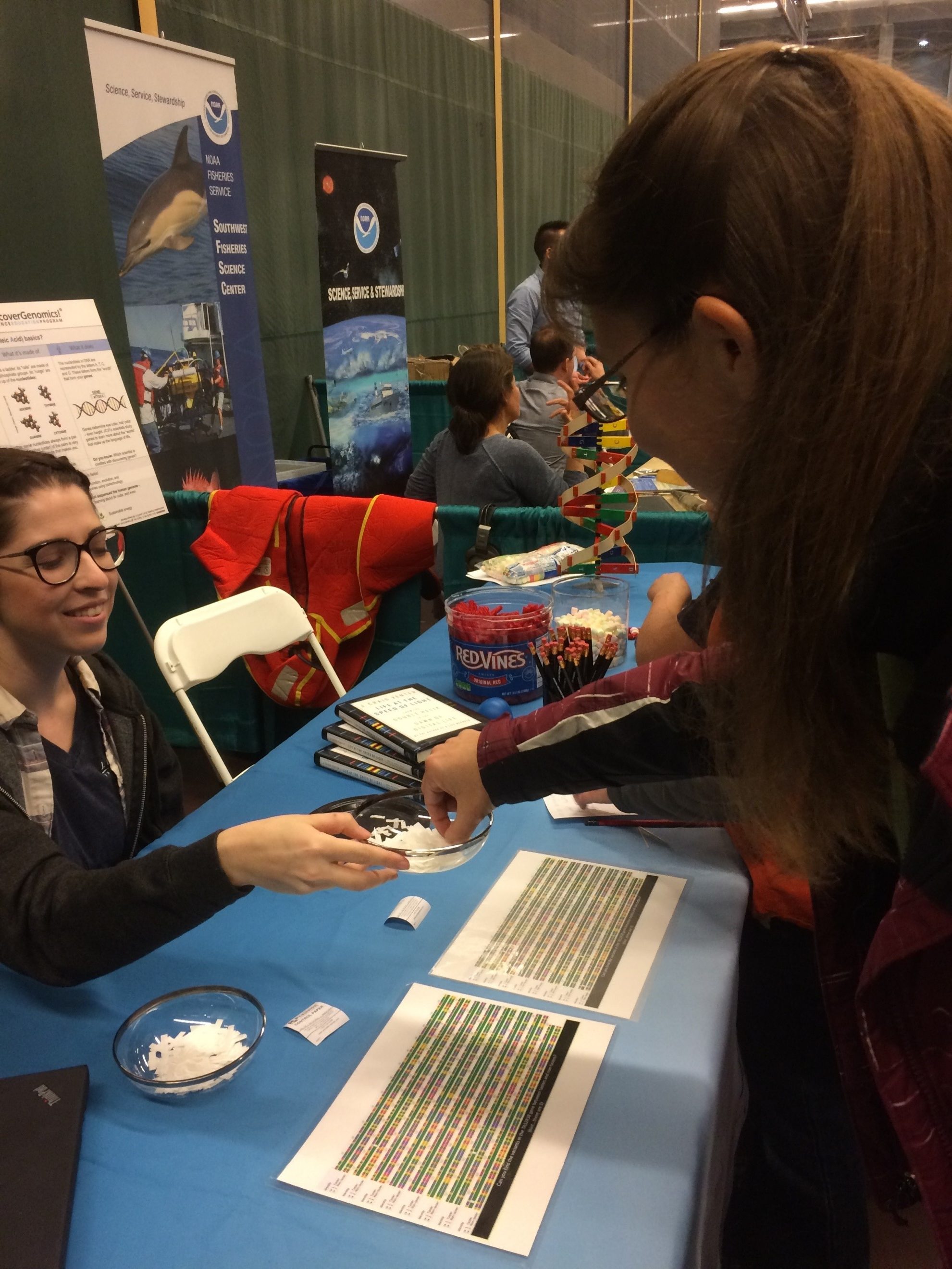 A student reaches in for a tasting strip to see if she can detect the bitter tastes of phenylthiocarbamide (PTC).